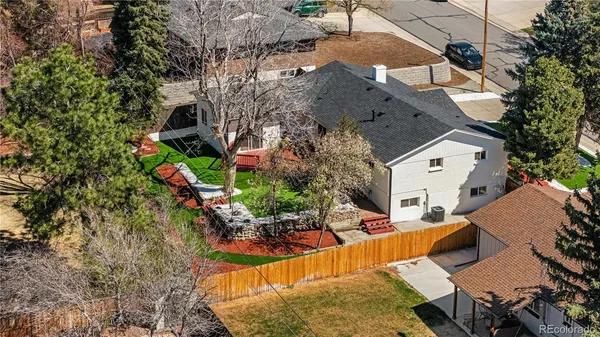 an aerial view of a house with a yard and lake view