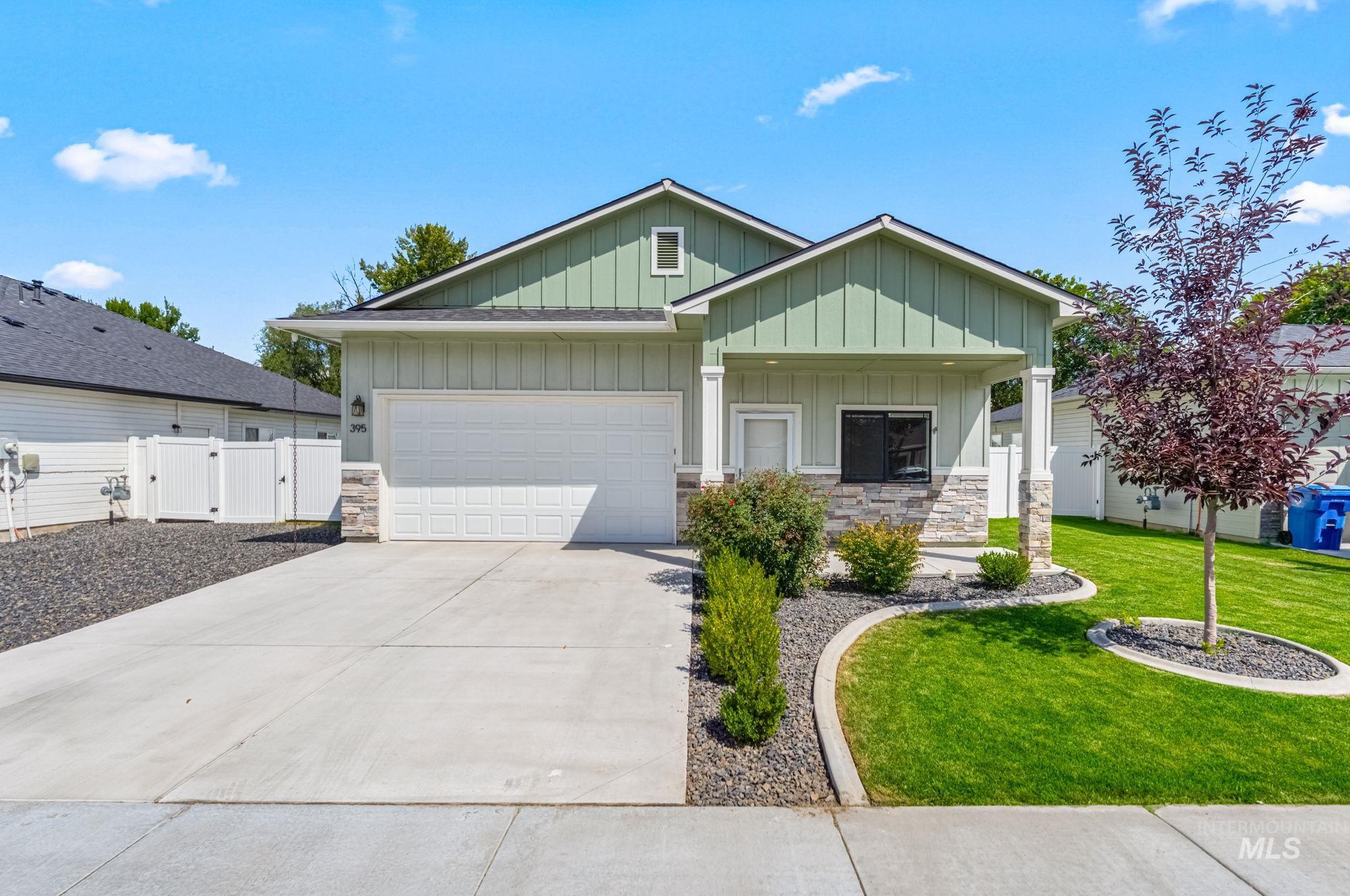 395 Cutlass Payette, ID 83661 - Photo 1 of 26 Craftsman-style home featuring board and batten siding, a gate, stone siding, an attached garage, and covered porch