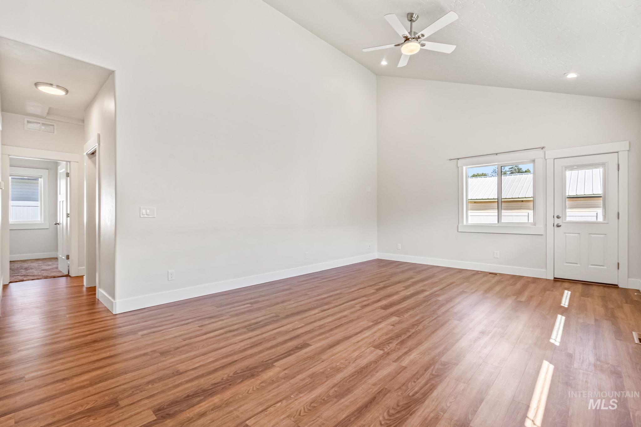 395 Cutlass Payette, ID 83661 - Photo 10 of 26 Unfurnished living room with light wood-style floors, high vaulted ceiling, ceiling fan, and recessed lighting