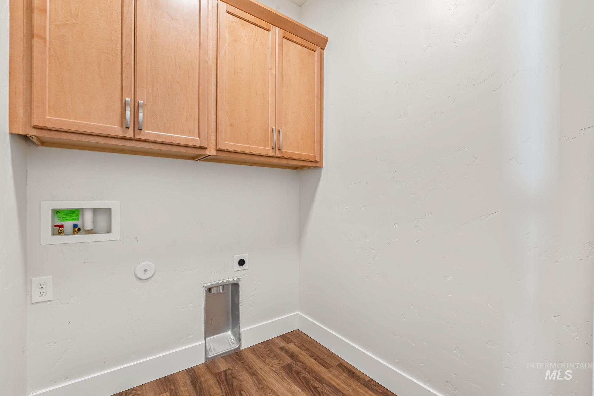395 Cutlass Payette, ID 83661 - Photo 11 of 26 Washroom with dark wood finished floors, cabinet space, hookup for an electric dryer, and washer hookup