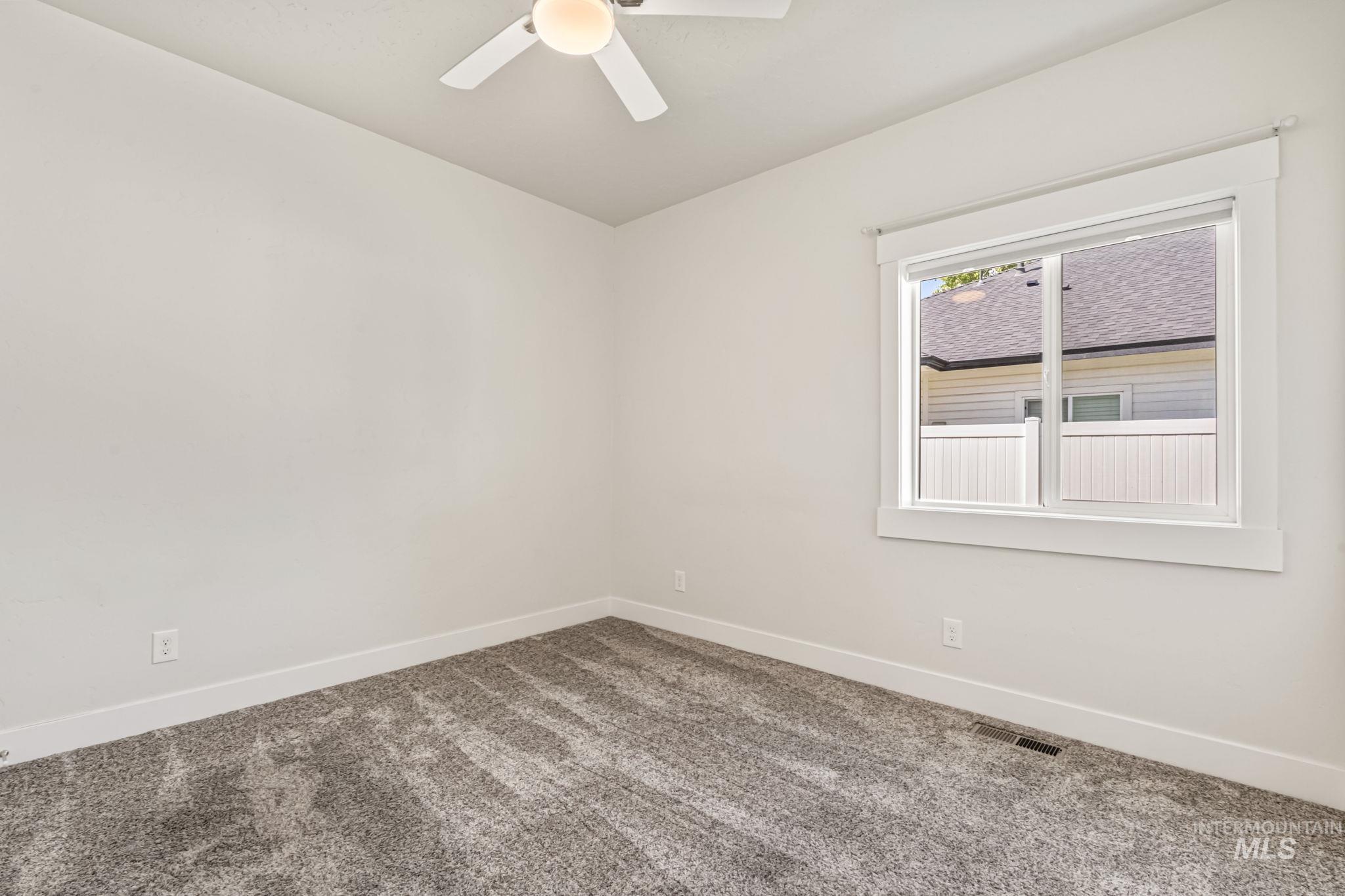 395 Cutlass Payette, ID 83661 - Photo 18 of 26 Empty room with carpet floors and ceiling fan