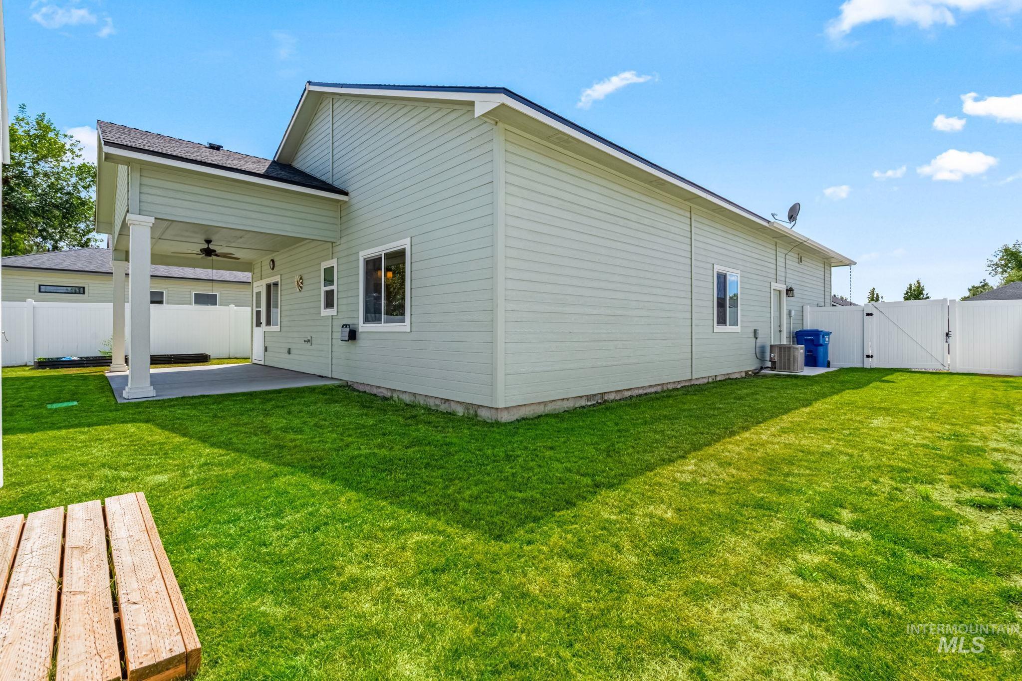 395 Cutlass Payette, ID 83661 - Photo 20 of 26 Rear view of house with a gate, a fenced backyard, ceiling fan, and a patio