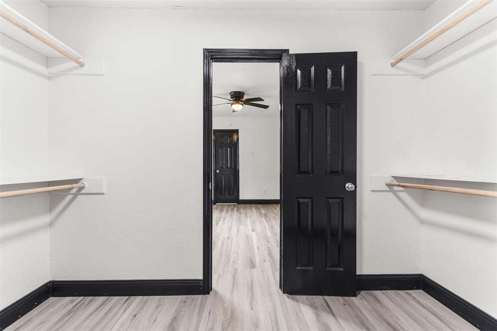 2802 Spring Valley Drive Bedford, TX 76021 - Photo 18 of 24 a view of a hallway with wooden floor and closet