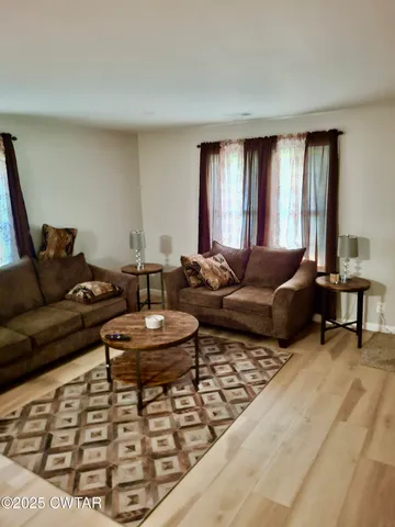 a living room with furniture and a large window
