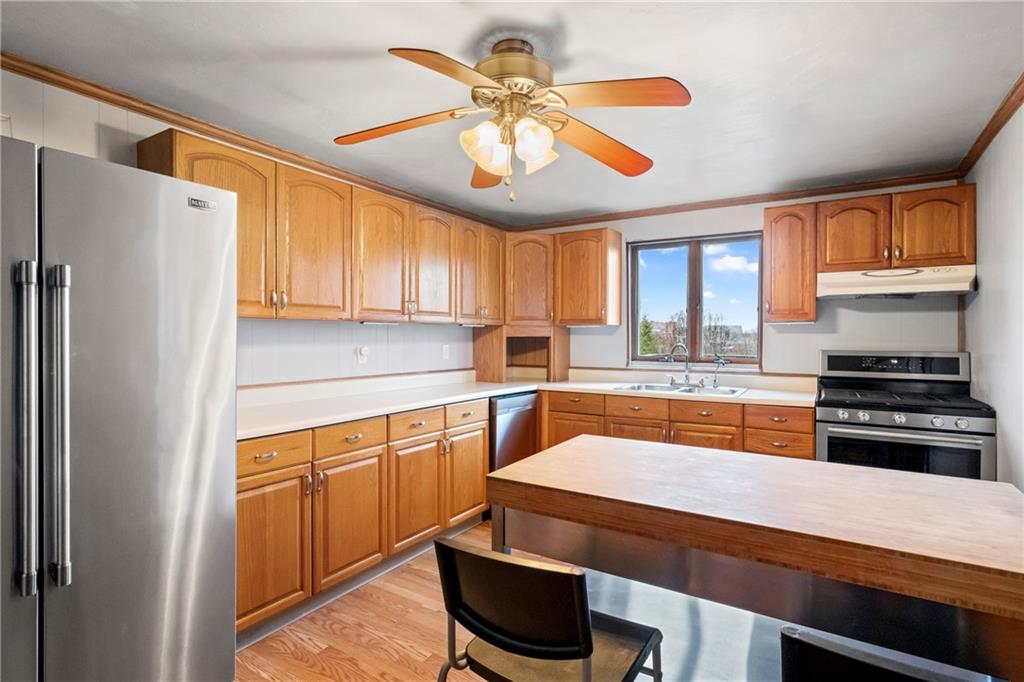 2725 Sumner Street Pittsburgh, PA 15203 - Photo 11 of 37 a kitchen with stainless steel appliances granite countertop a stove a sink and a refrigerator