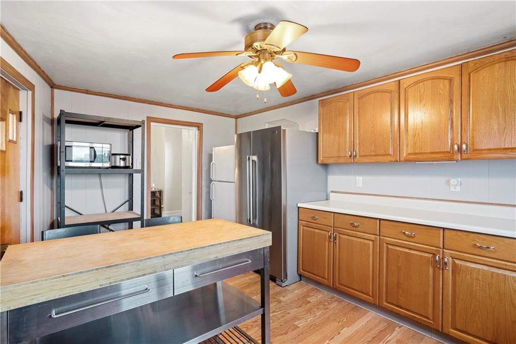 2725 Sumner Street Pittsburgh, PA 15203 - Photo 12 of 37 a room with kitchen island a sink and wooden cabinets