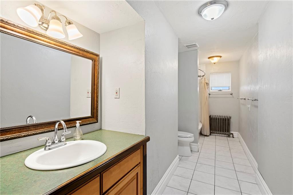 2725 Sumner Street Pittsburgh, PA 15203 - Photo 18 of 37 a bathroom with a sink and a mirror