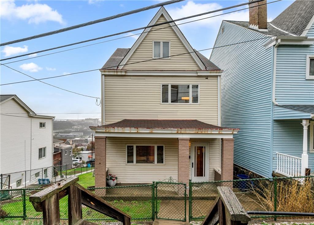 2725 Sumner Street Pittsburgh, PA 15203 - Photo 33 of 37 a view of a house with a small yard and wooden fence