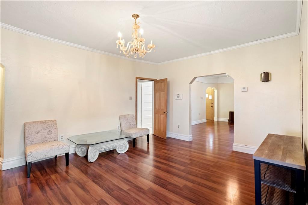 2725 Sumner Street Pittsburgh, PA 15203 - Photo 9 of 37 a living room with furniture and a chandelier