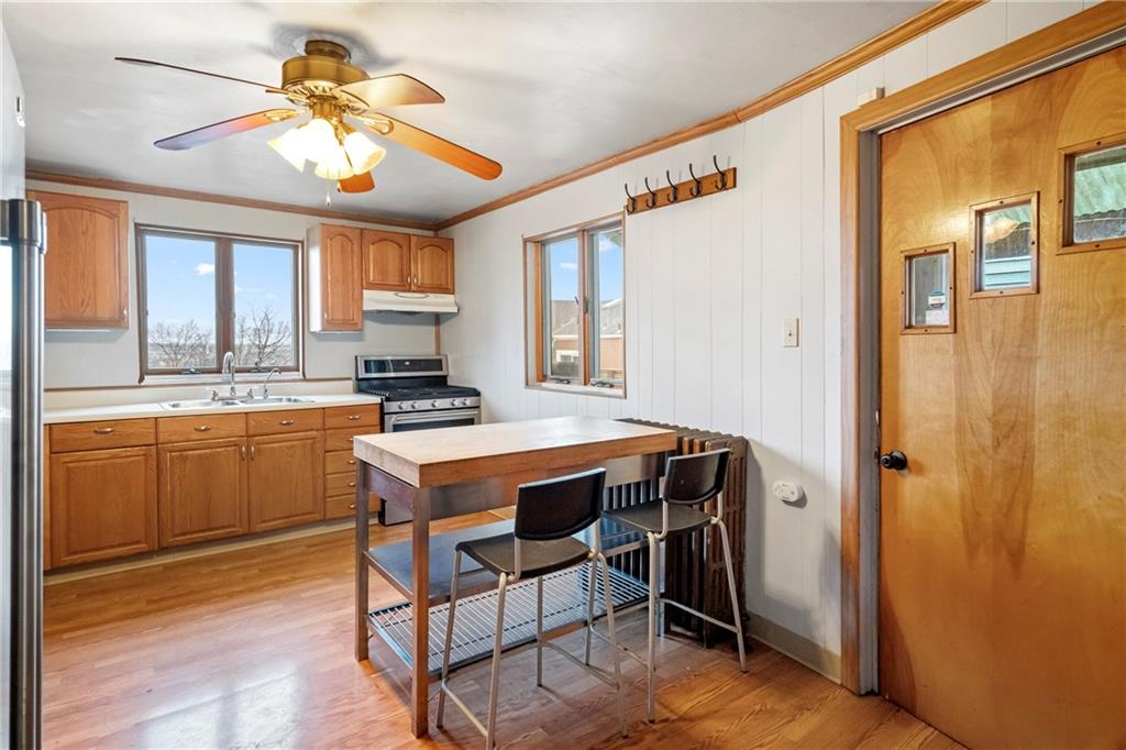 2725 Sumner Street Pittsburgh, PA 15203 - Photo 10 of 37 a kitchen with a table chairs refrigerator and cabinets