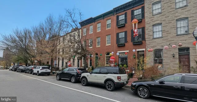 a view of a cars park in front of a brick building