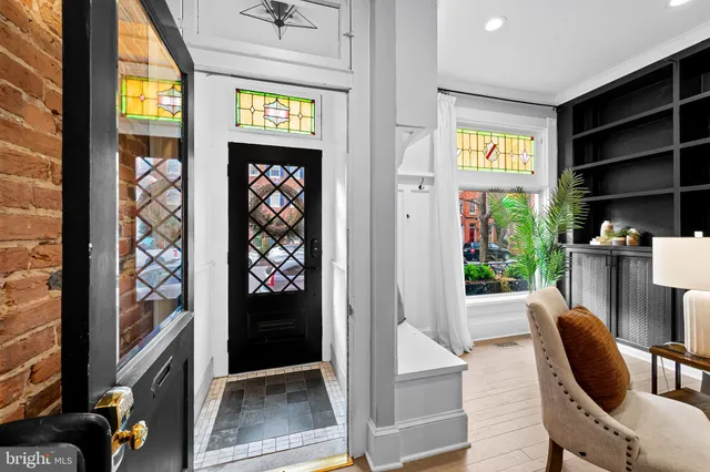 a view of a hallway with wooden floor and a window