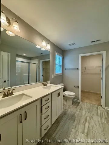 a view of bathroom with a sink mirror and toilet