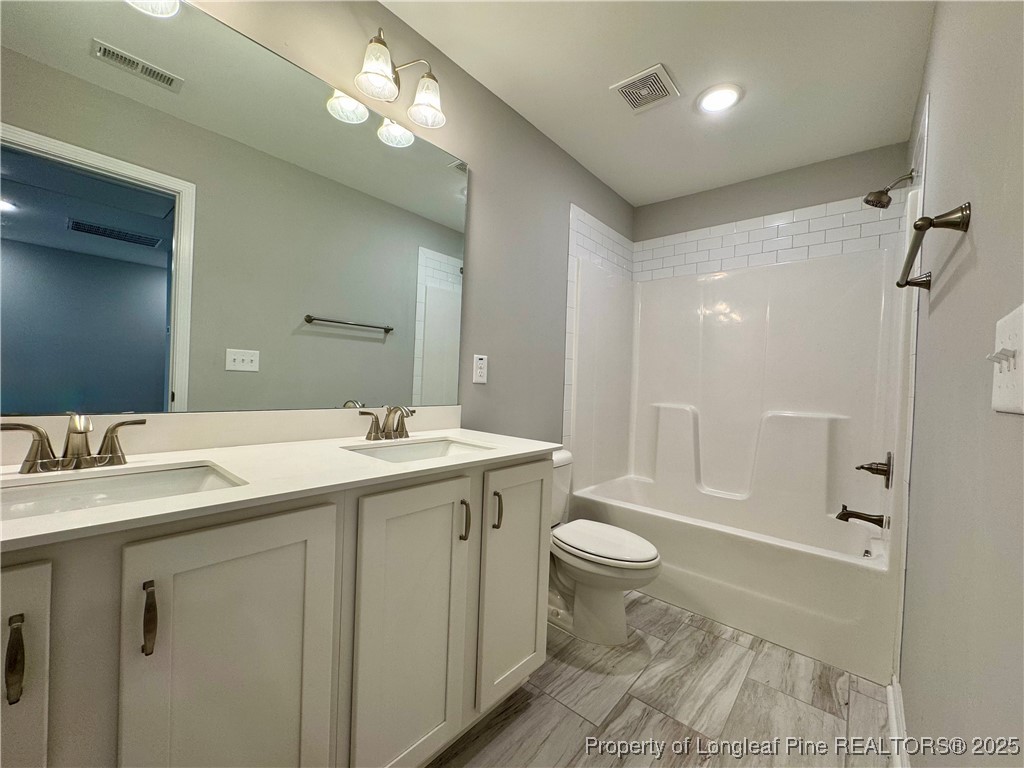 808 Jackson Street Raeford, NC 28376 - Photo 17 of 21 a bathroom with a granite countertop sink toilet and shower