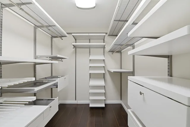 a view of walk in closet with empty racks