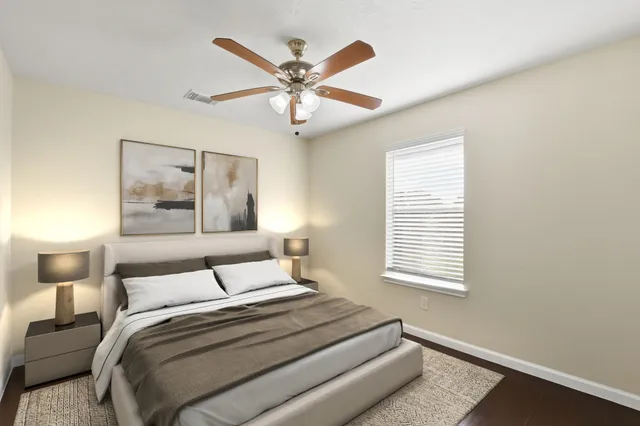 a bedroom with a large bed and a window