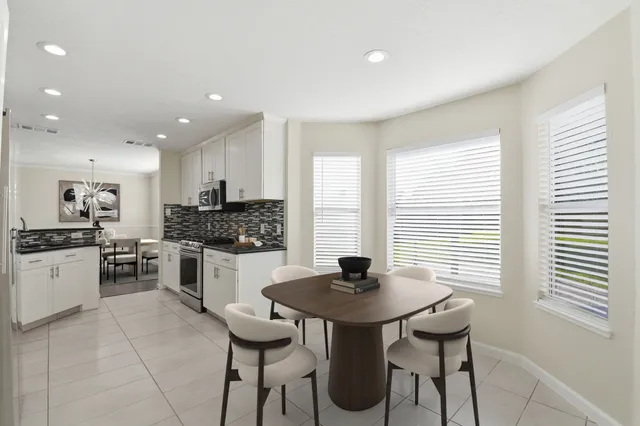 a kitchen with a table and chairs in it
