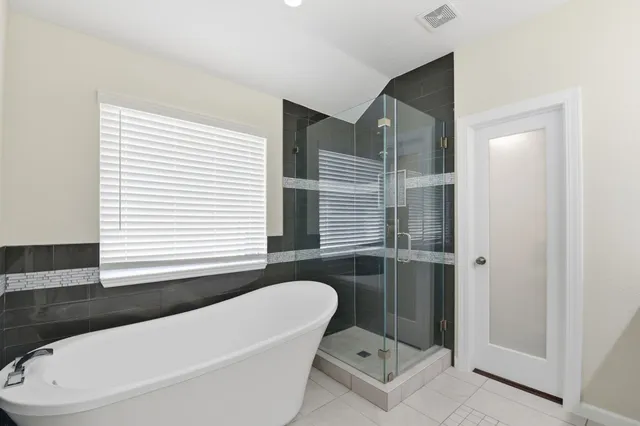 a bathroom with a bathtub and a shower