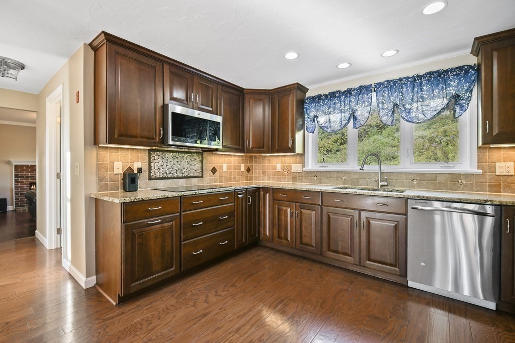 82 Buttermilk Road Leominster, MA 01453 - Photo 11 of 42 a kitchen with stainless steel appliances granite countertop a stove a sink and a microwave