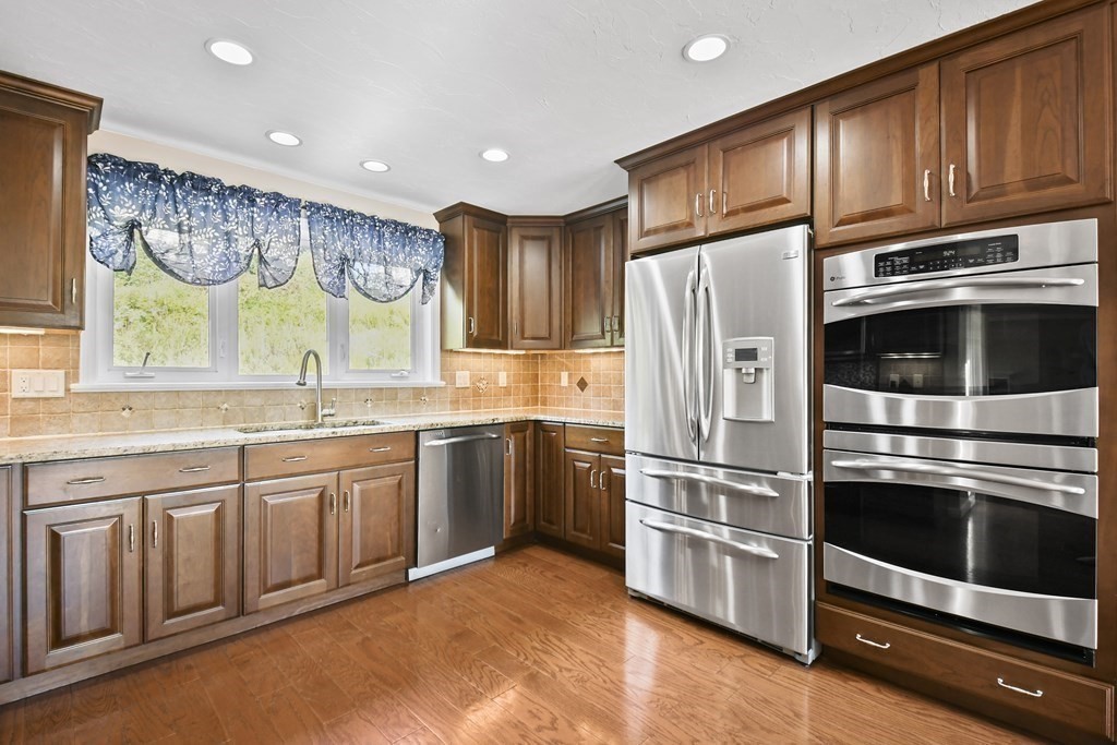 82 Buttermilk Road Leominster, MA 01453 - Photo 12 of 42 a kitchen with stainless steel appliances granite countertop a refrigerator and a stove top oven