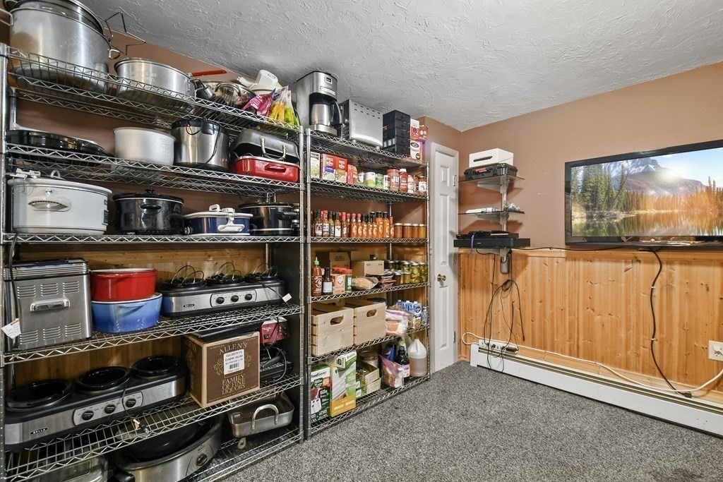 82 Buttermilk Road Leominster, MA 01453 - Photo 30 of 42 a room with lots of books and a refrigerator