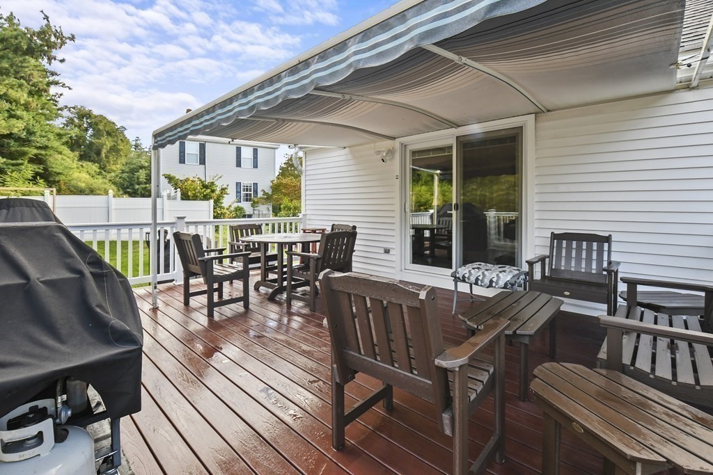 82 Buttermilk Road Leominster, MA 01453 - Photo 31 of 42 a view of a patio with a dining table and chairs with wooden floor