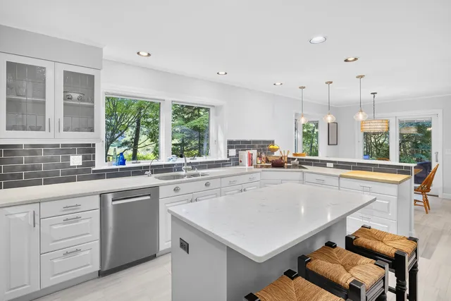 a living room with furniture large window and a fireplace