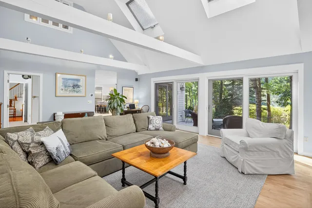 a bedroom with a large bed couch and a window