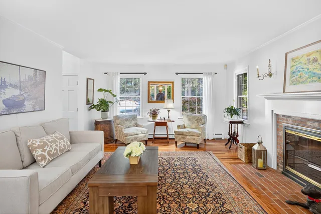 a view of a livingroom with workspace and a window