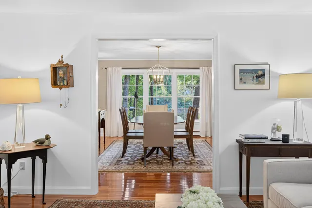 a living room with hard wood floors and a book shelf