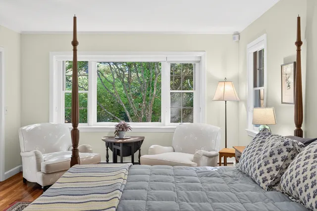 a view of a house with a yard and tree s