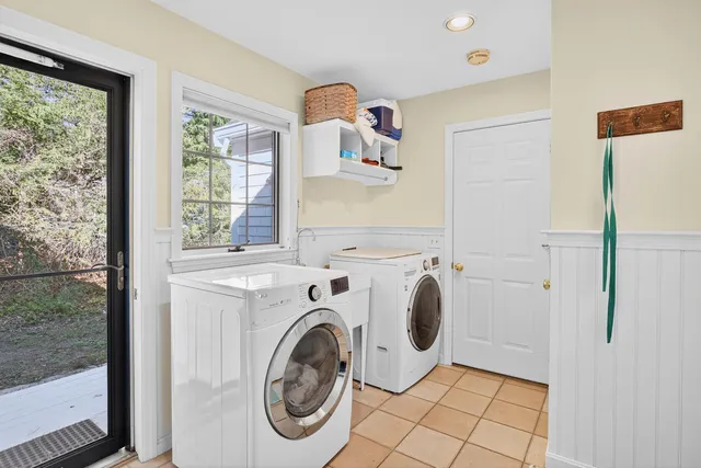 an aerial view of a house with a yard and trees all around