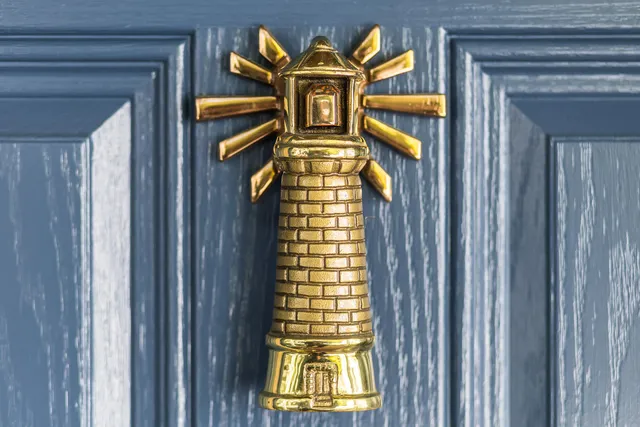 a kitchen with stainless steel appliances white cabinets and a large window