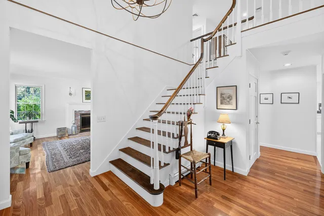 a kitchen with stainless steel appliances granite countertop a stove a kitchen island a dining table and chairs