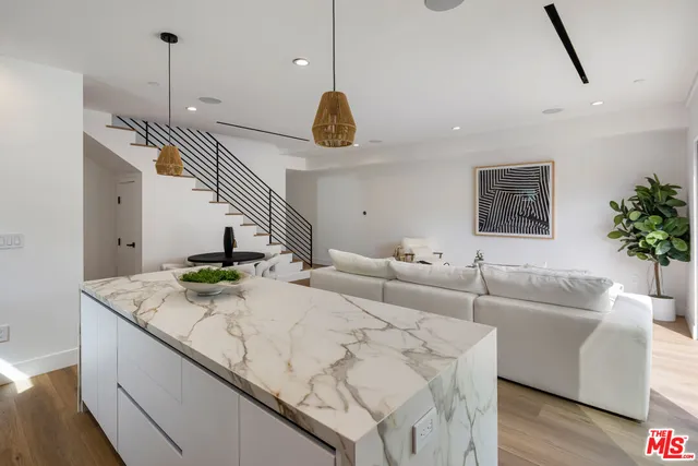 a living room with couches and pool table