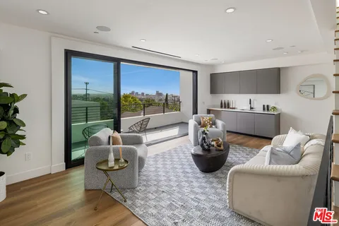 a living room with furniture and a potted plant