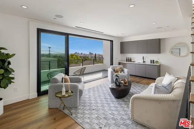a living room with furniture and a potted plant