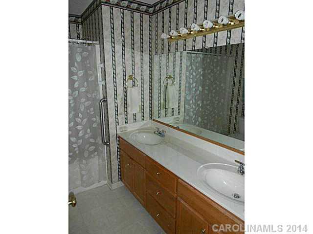 3871 River Road Hickory, NC 28602 - Photo 7 of 16 a bathroom with a granite countertop sink a mirror and shower