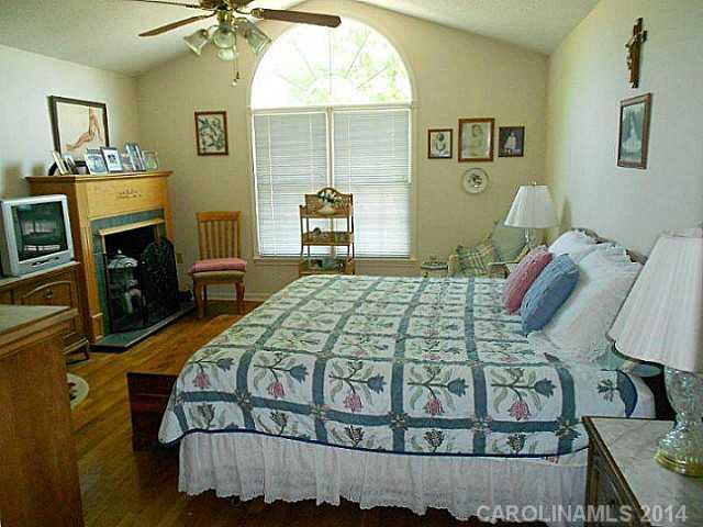 3871 River Road Hickory, NC 28602 - Photo 9 of 16 a bedroom with a bed and a fireplace