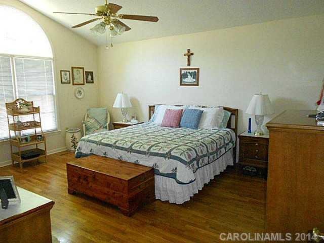 3871 River Road Hickory, NC 28602 - Photo 10 of 16 a bedroom with a bed wooden floor and window