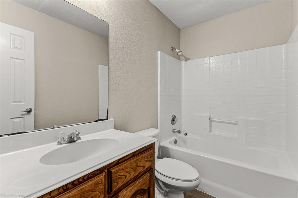 2821 Mockingbird Street Royse City, TX 75189 - Photo 13 of 21 a bathroom with a sink a toilet and a bathtub