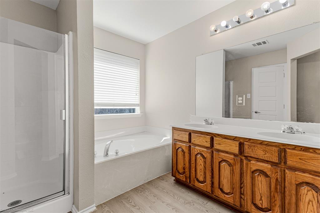 2821 Mockingbird Street Royse City, TX 75189 - Photo 16 of 21 a bathroom with a bathtub sink and mirror