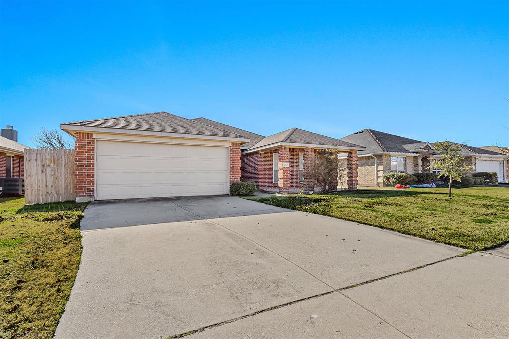 2821 Mockingbird Street Royse City, TX 75189 - Photo 2 of 21 a front view of a house with a yard and garage