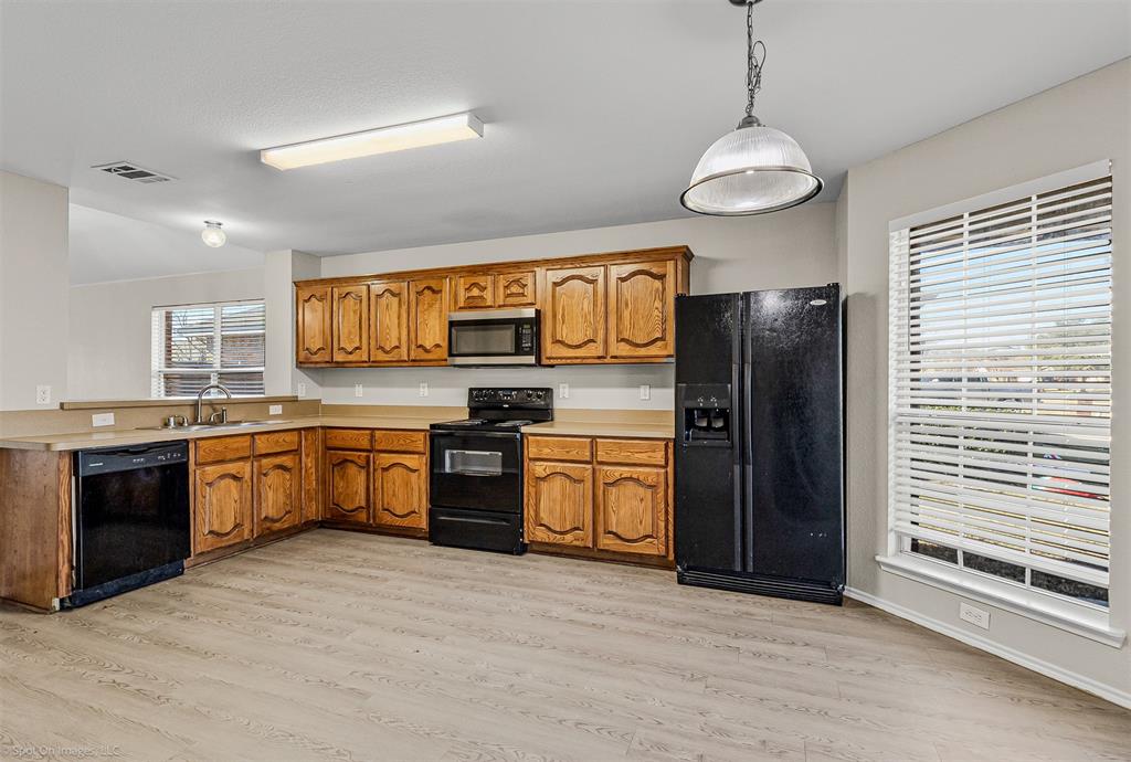 2821 Mockingbird Street Royse City, TX 75189 - Photo 5 of 21 a large kitchen with stainless steel appliances granite countertop a stove refrigerator and cabinets
