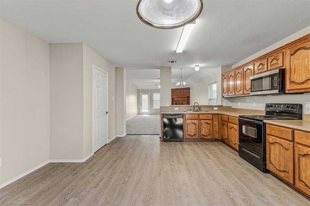 2821 Mockingbird Street Royse City, TX 75189 - Photo 7 of 21 a kitchen with stainless steel appliances a refrigerator and a stove top oven