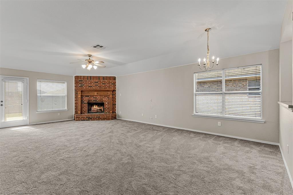 2821 Mockingbird Street Royse City, TX 75189 - Photo 9 of 21 an empty room with windows and fireplace