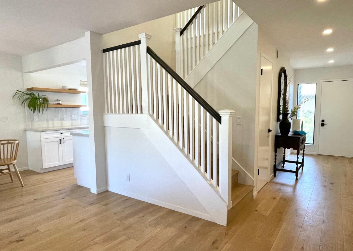 3850 Rio Road, Unit 91 Carmel, CA 93923 - Photo 15 of 31 a view of a hallway with wooden floor and entryway