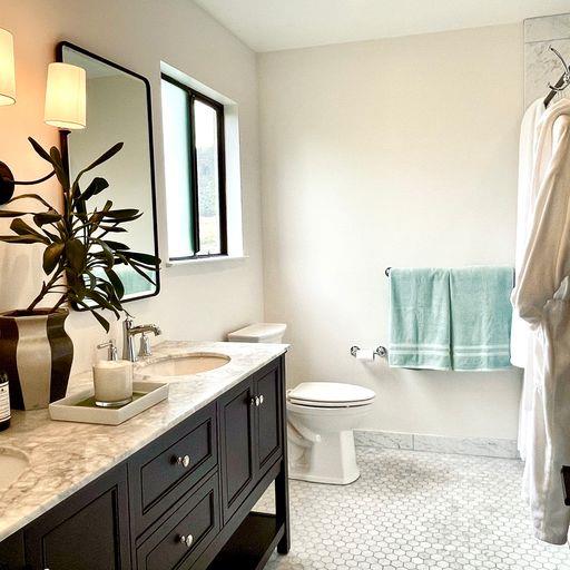 3850 Rio Road, Unit 91 Carmel, CA 93923 - Photo 18 of 31 a bathroom with a granite countertop sink a toilet and a mirror