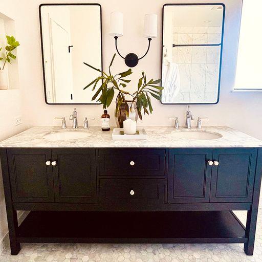 3850 Rio Road, Unit 91 Carmel, CA 93923 - Photo 19 of 31 a bathroom with a double vanity sink and a mirror