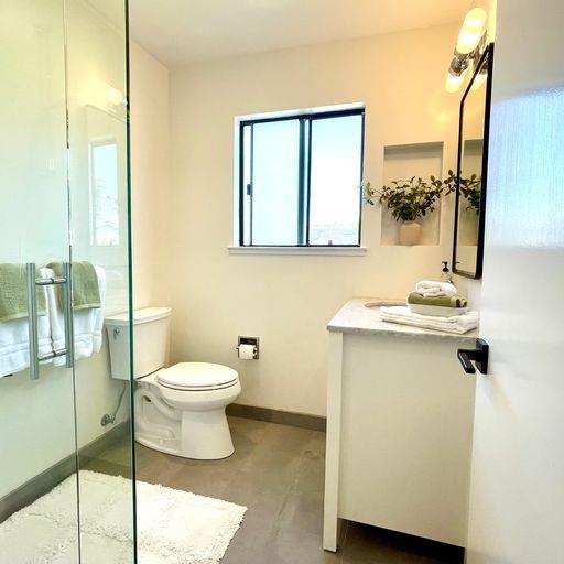 3850 Rio Road, Unit 91 Carmel, CA 93923 - Photo 24 of 31 a bathroom with a toilet sink and mirror